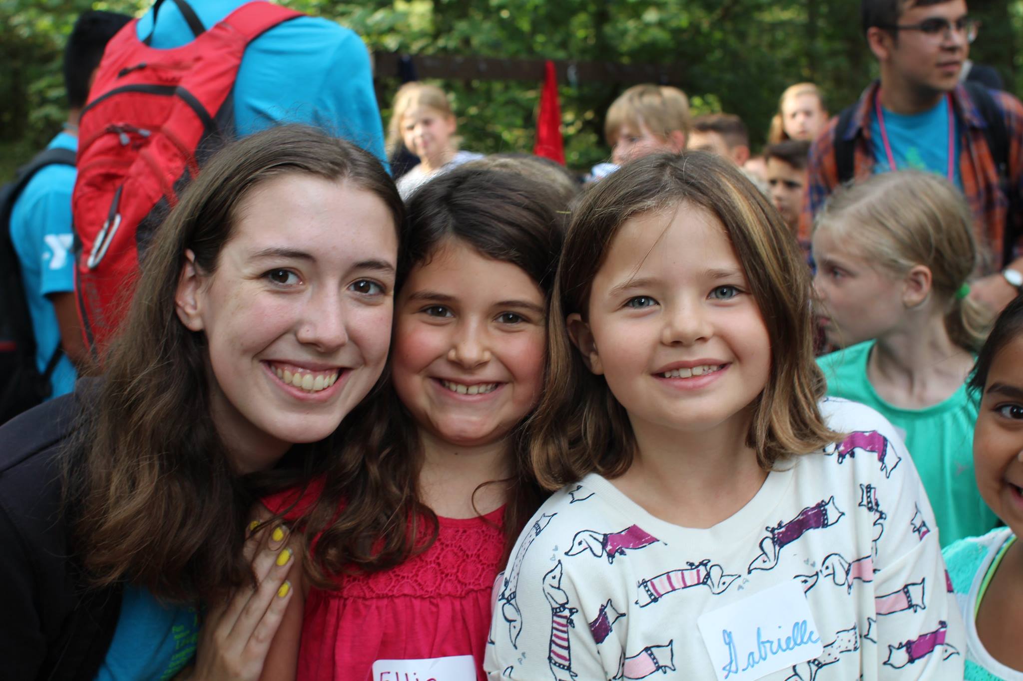 Camp counselor and children smiling