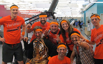 Group of people stand together smiling